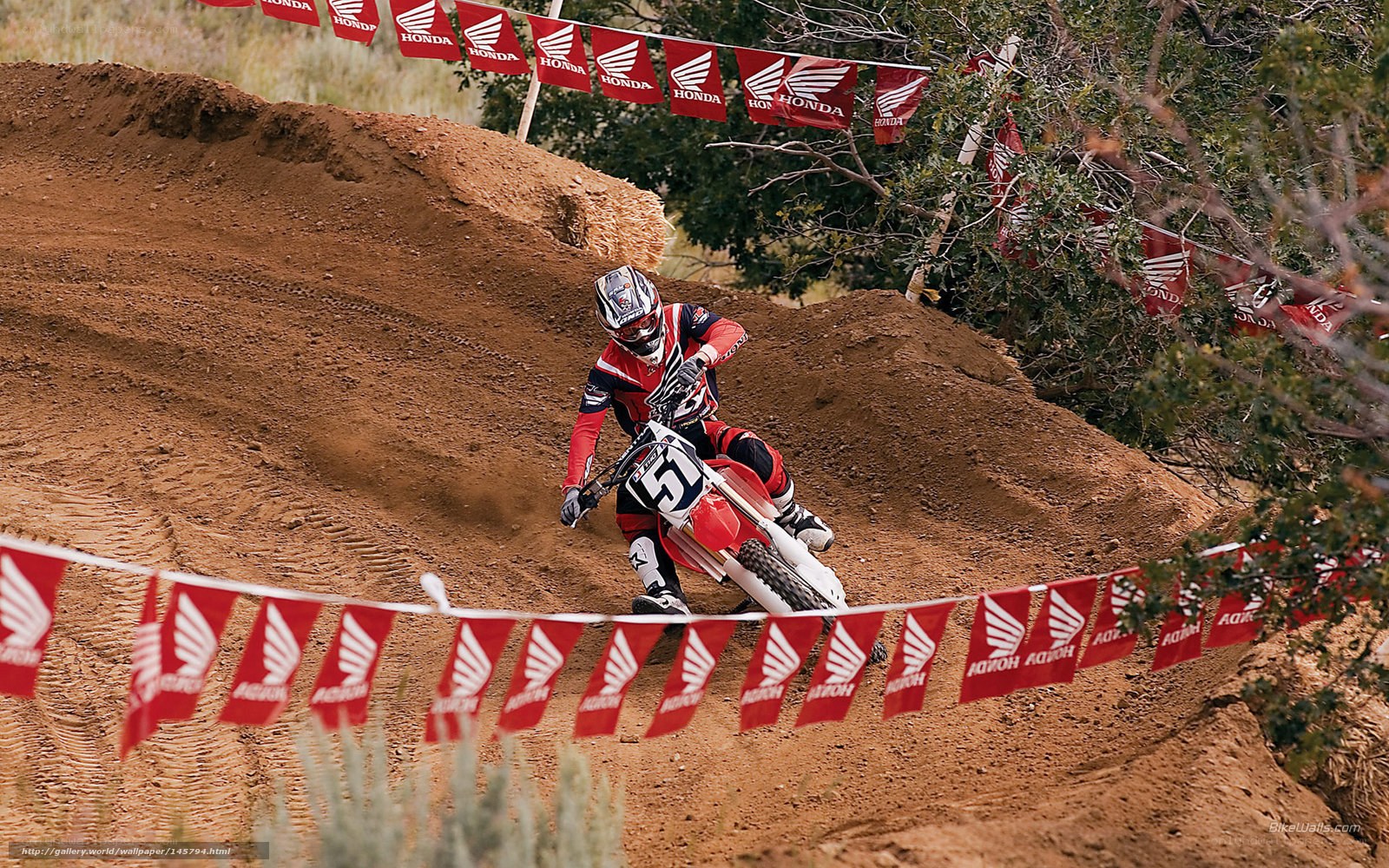 Motocross rider on dirt track