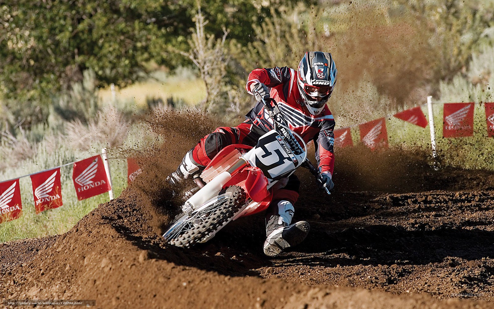 Motocross rider on dirt track