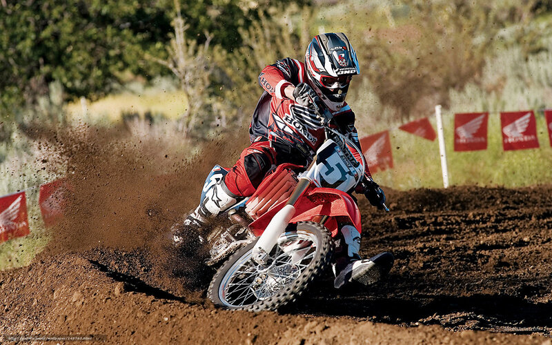Motocross rider on dirt track