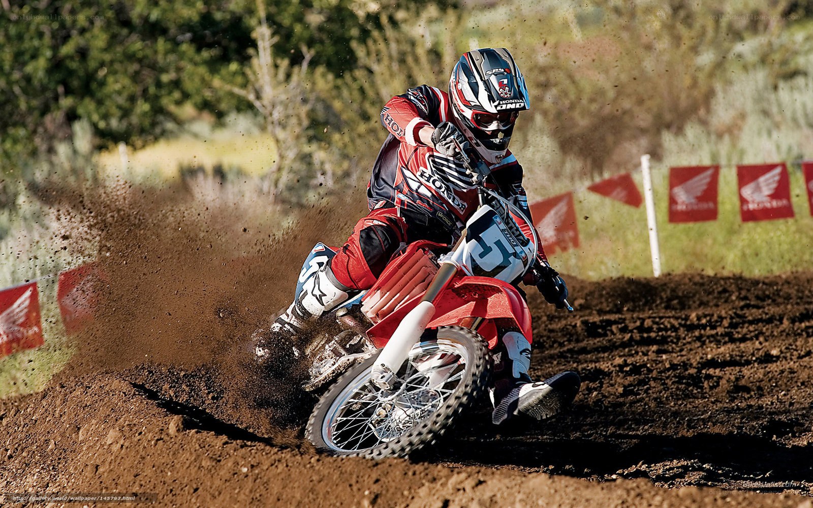 Motocross rider on dirt track