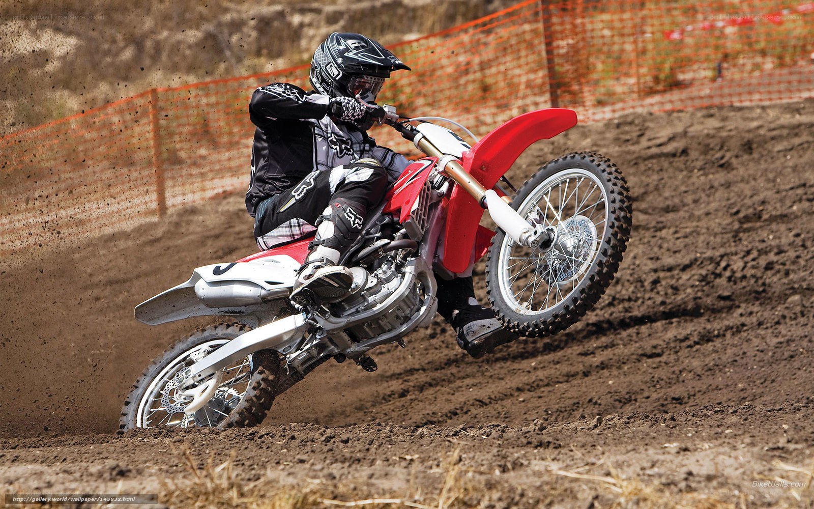Motocross rider on dirt track