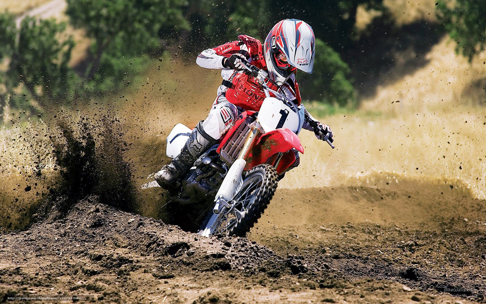 Motocross rider on dirt track