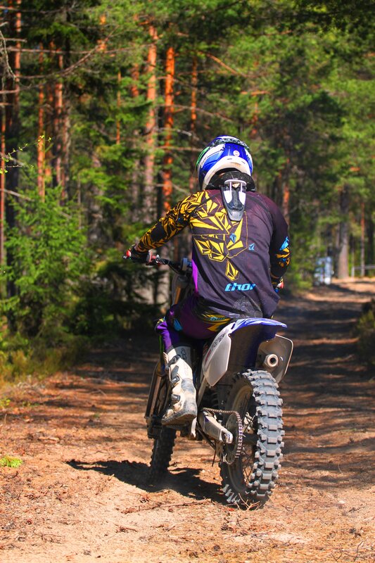Motocross rider on forest trail