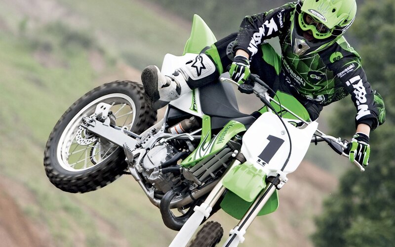 Motocross rider on green bike