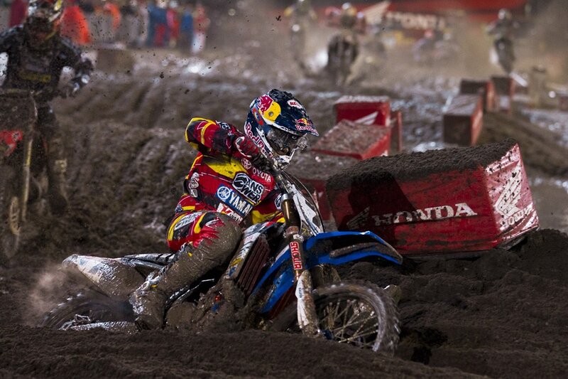 Motocross rider on muddy track