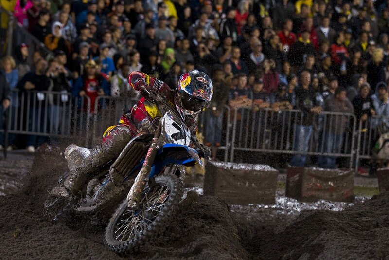 Motocross rider on muddy track