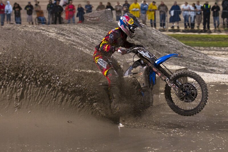 Motocross rider on muddy track
