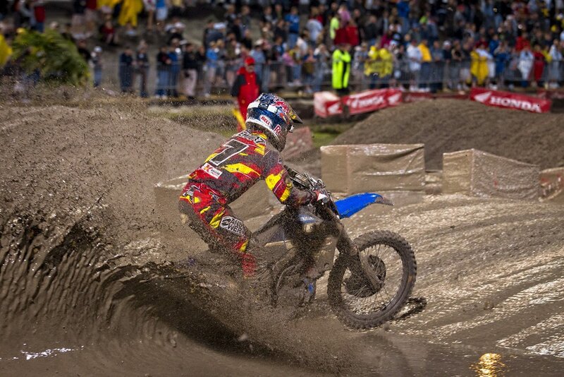 Motocross rider on muddy track