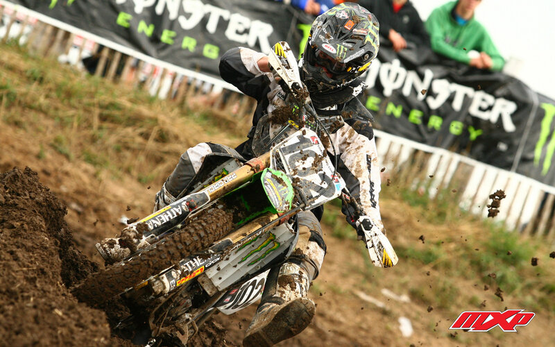 Motocross rider on muddy track