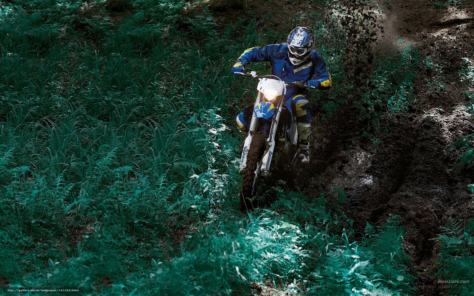 Motocross rider on muddy trail