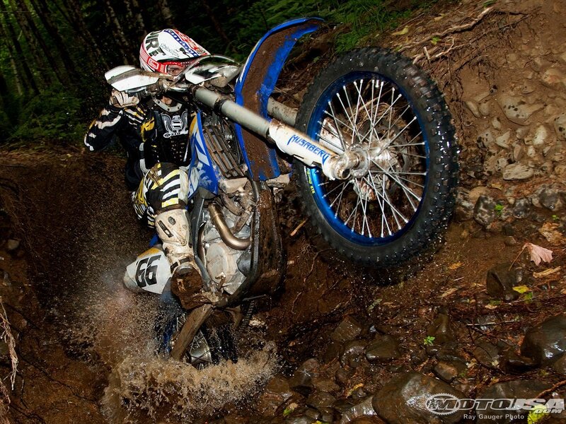 Motocross rider on muddy trail