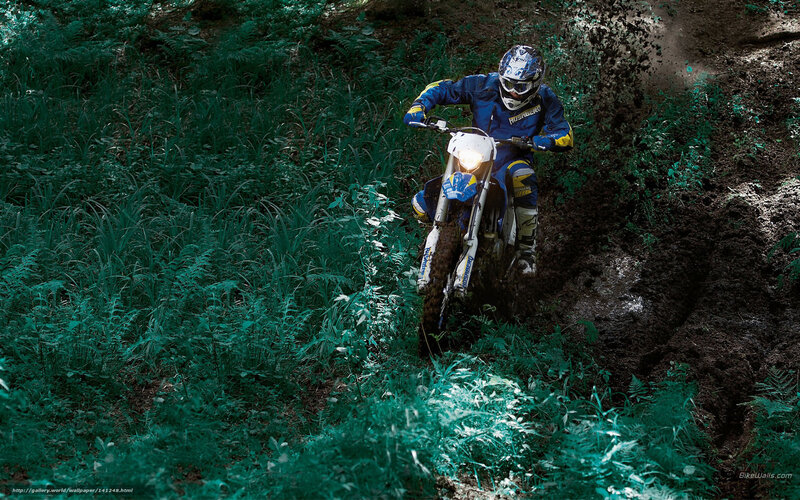 Motocross rider on muddy trail