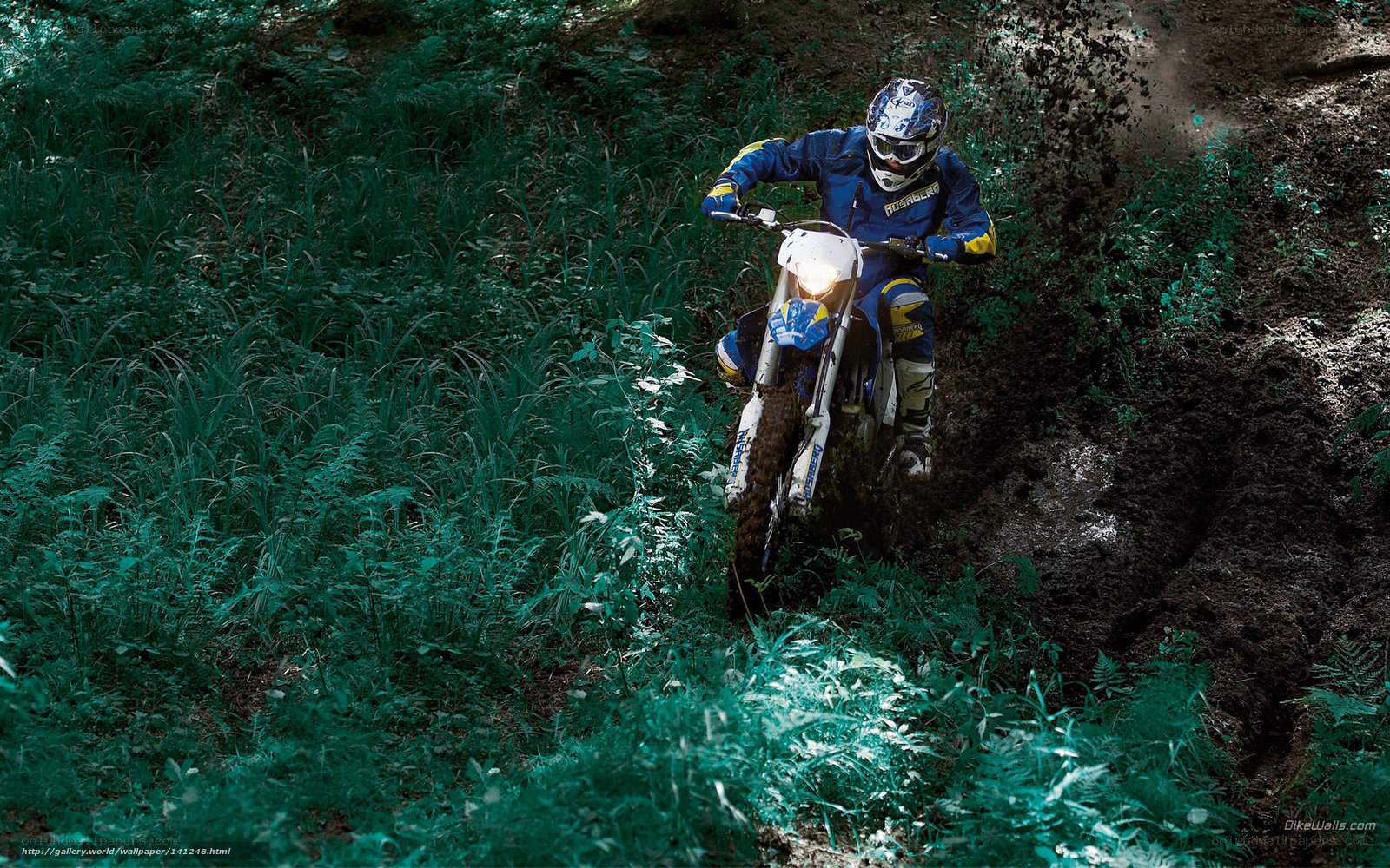 Motocross rider on muddy trail