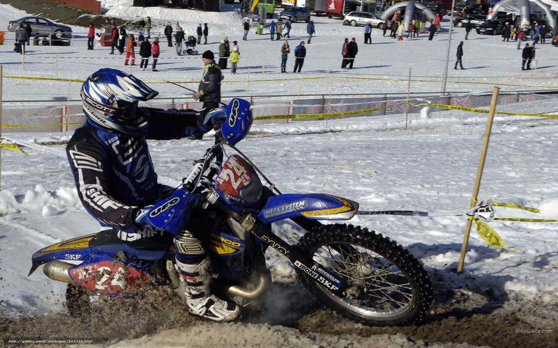 Motocross rider on snowy track