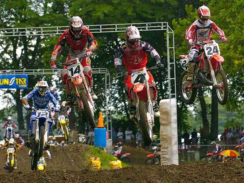 Motocross riders in mid-air jump