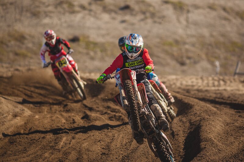 Motocross riders on dirt track