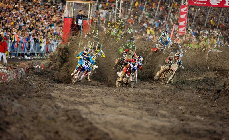 Motocross riders racing on dirt track