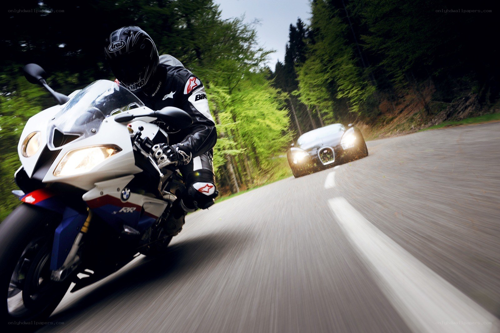 Motorcycle and car on forest road