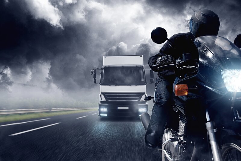 motorcycle and truck on highway