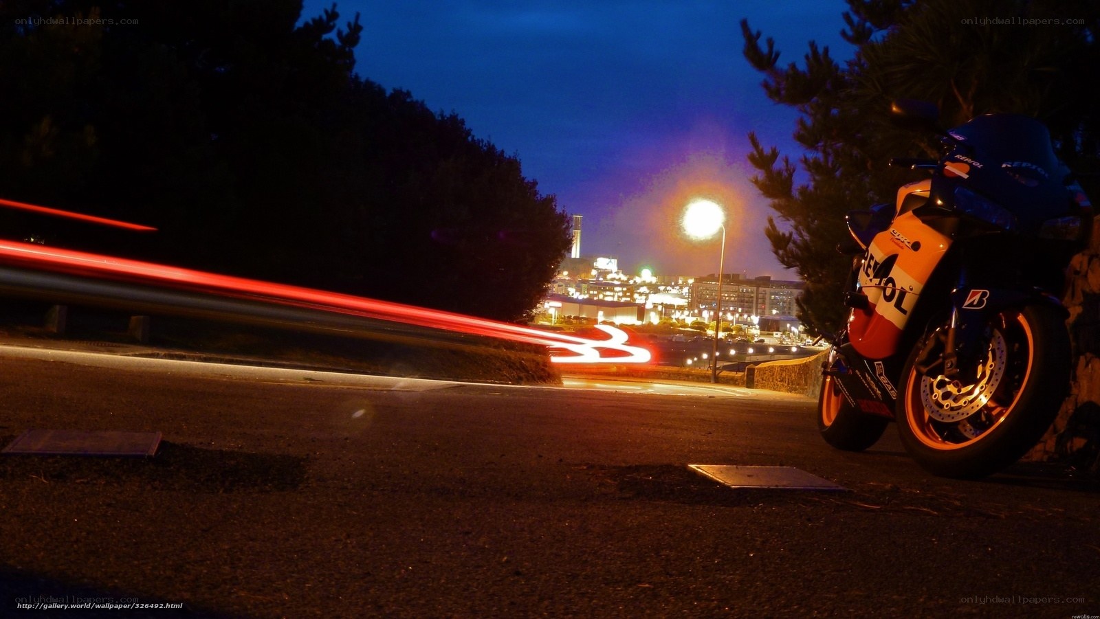 Motorcycle at night with city lights