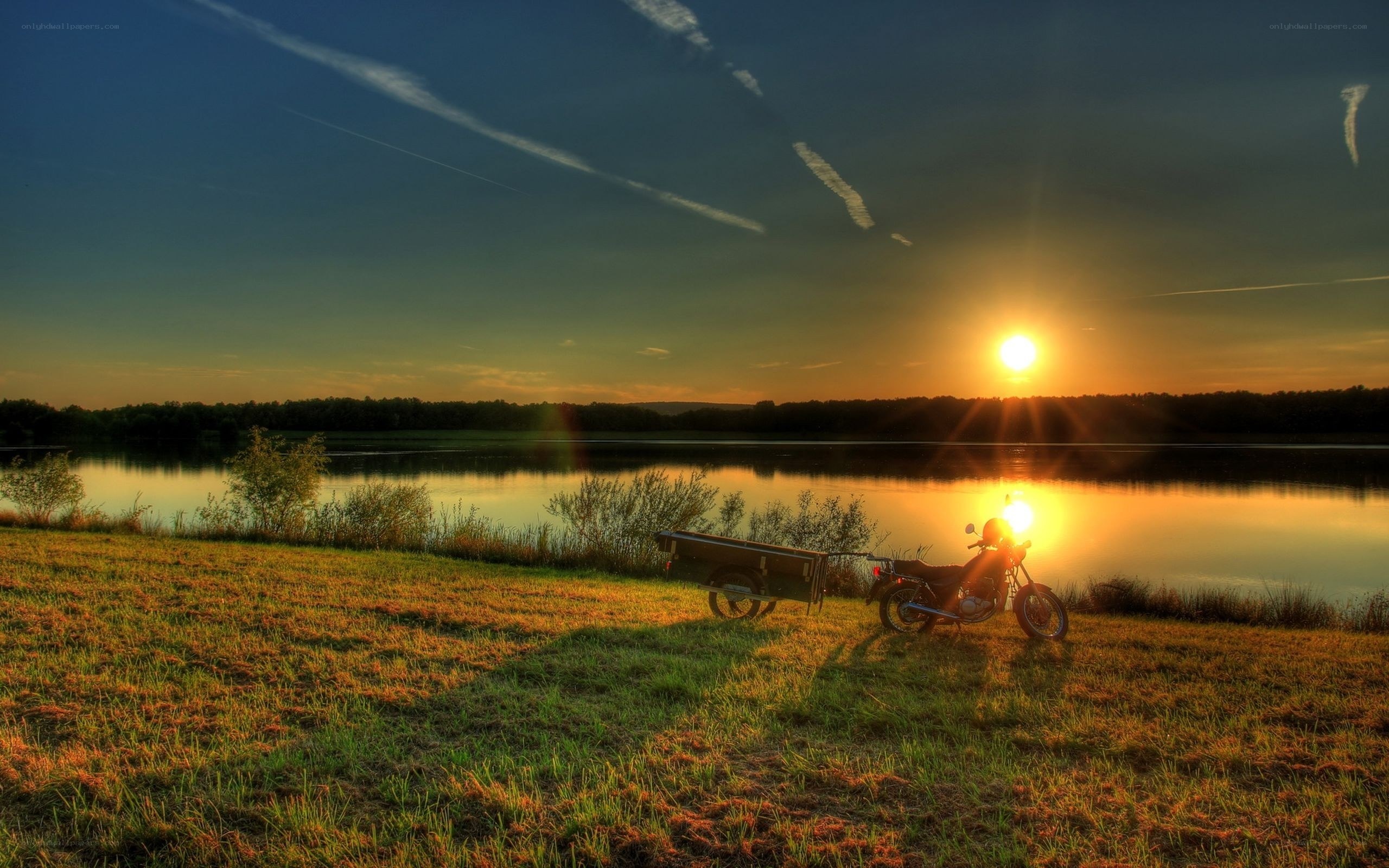 Motorcycle at sunset by the lake