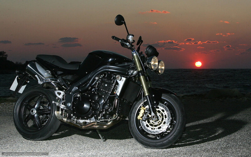 motorcycle at sunset by the sea