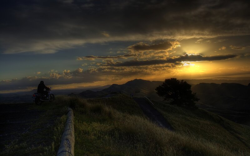Motorcycle at sunset on a hill