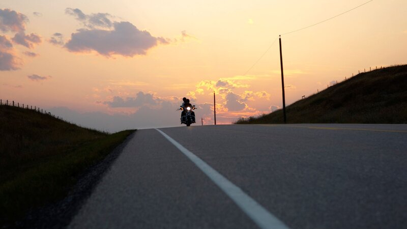 Motorcycle at sunset on country road