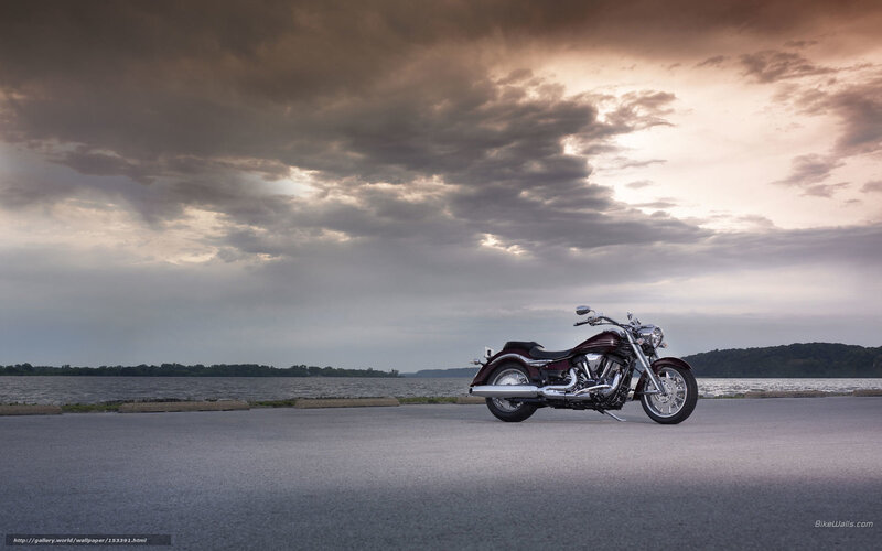 Motorcycle by the lake at sunset