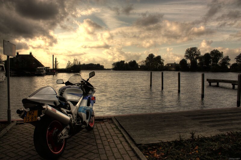 motorcycle by the water at sunset