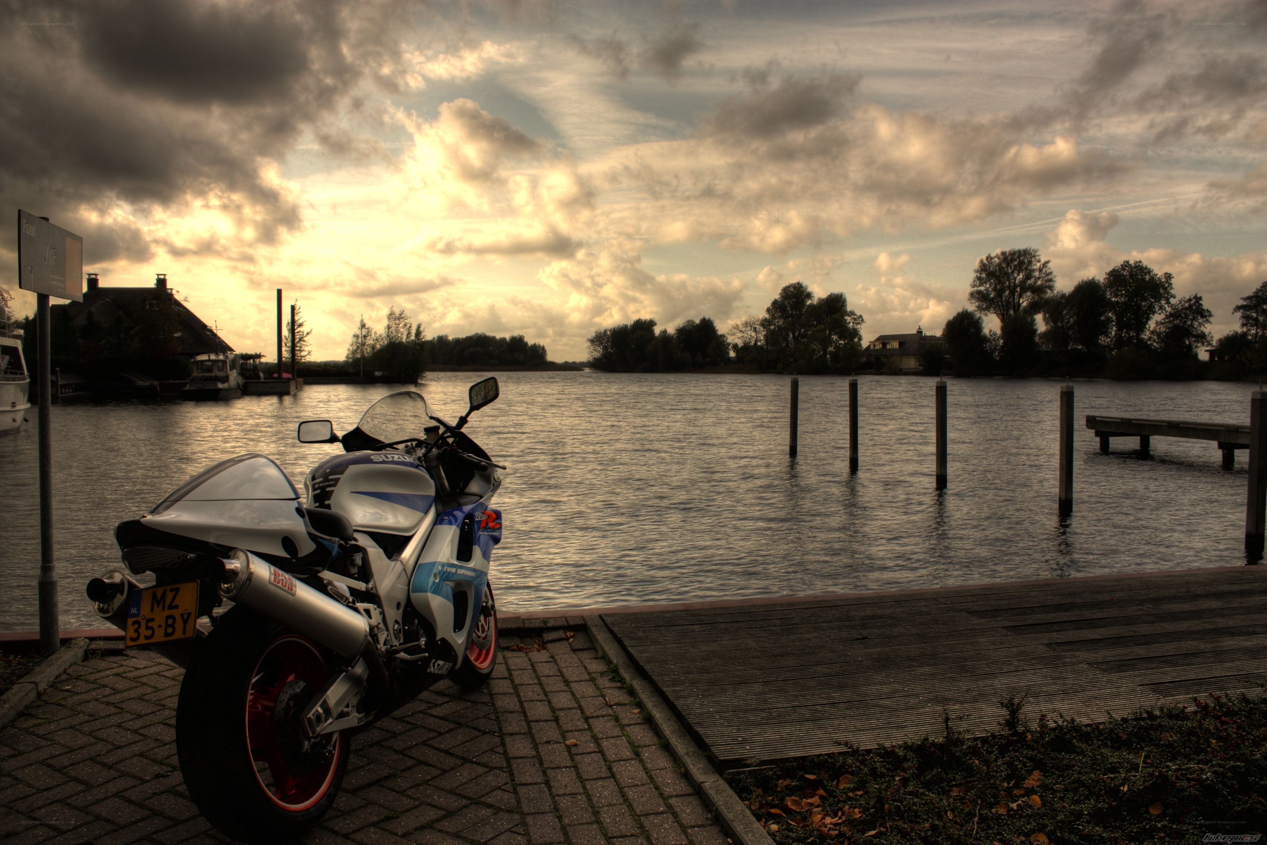 motorcycle by the water at sunset