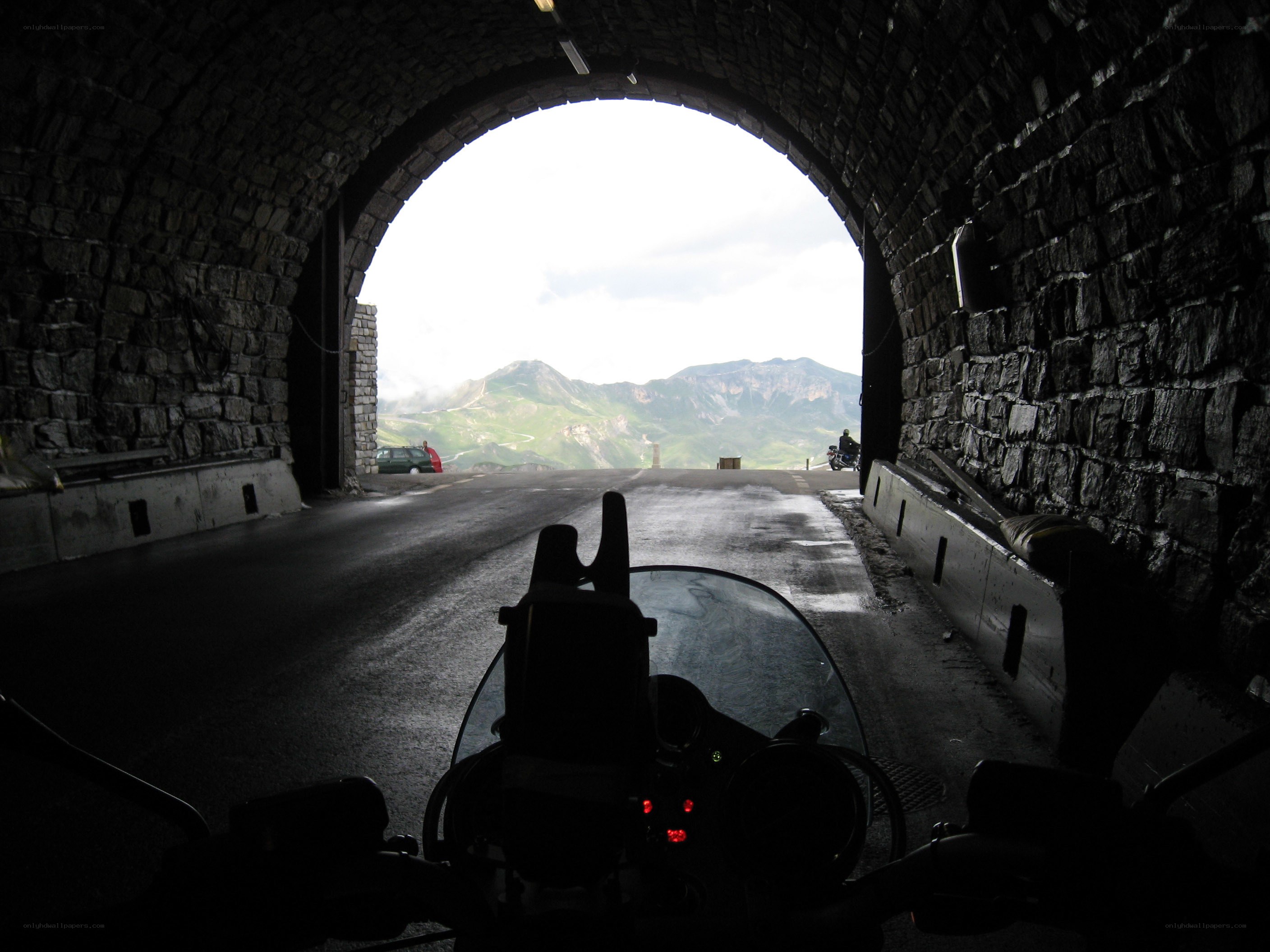 Motorcycle exiting mountain tunnel