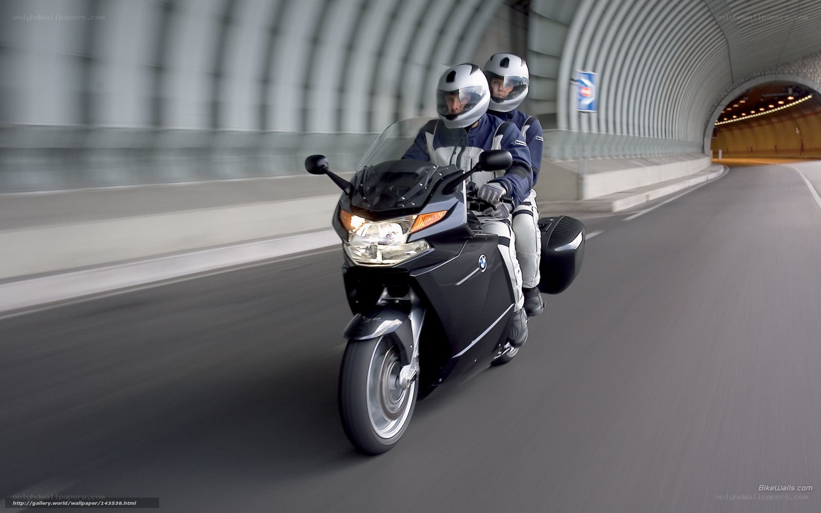 Motorcycle in tunnel with passengers