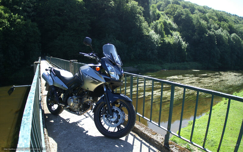 Motorcycle on a bridge over a river
