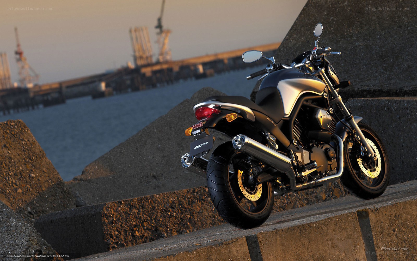 motorcycle on a pier at sunset