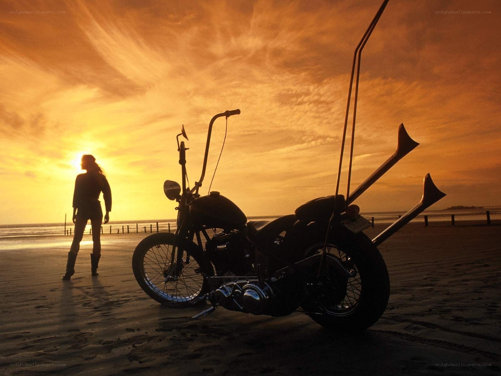 Motorcycle on beach at sunset