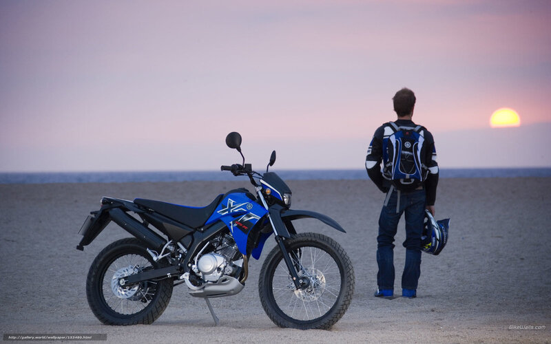 Motorcycle on beach at sunset