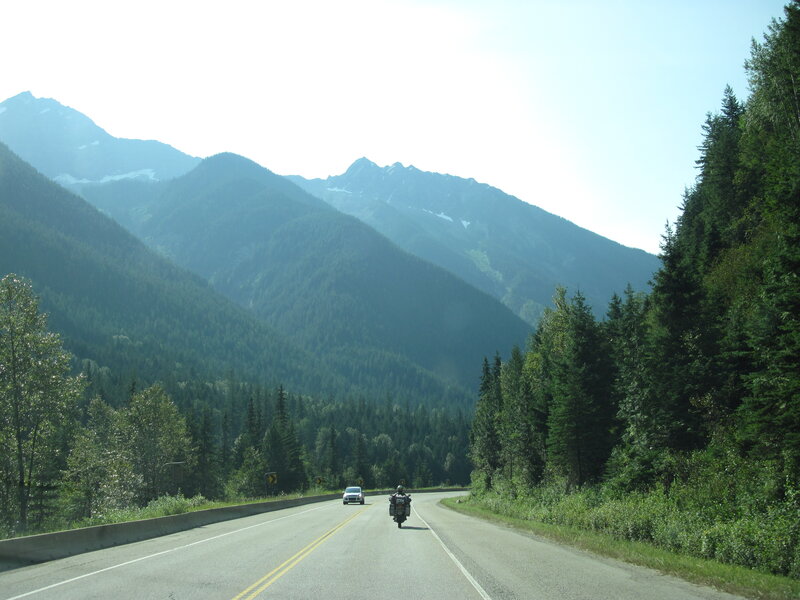 Motorcycle on Mountain Road — Green, Serene, Afternoon