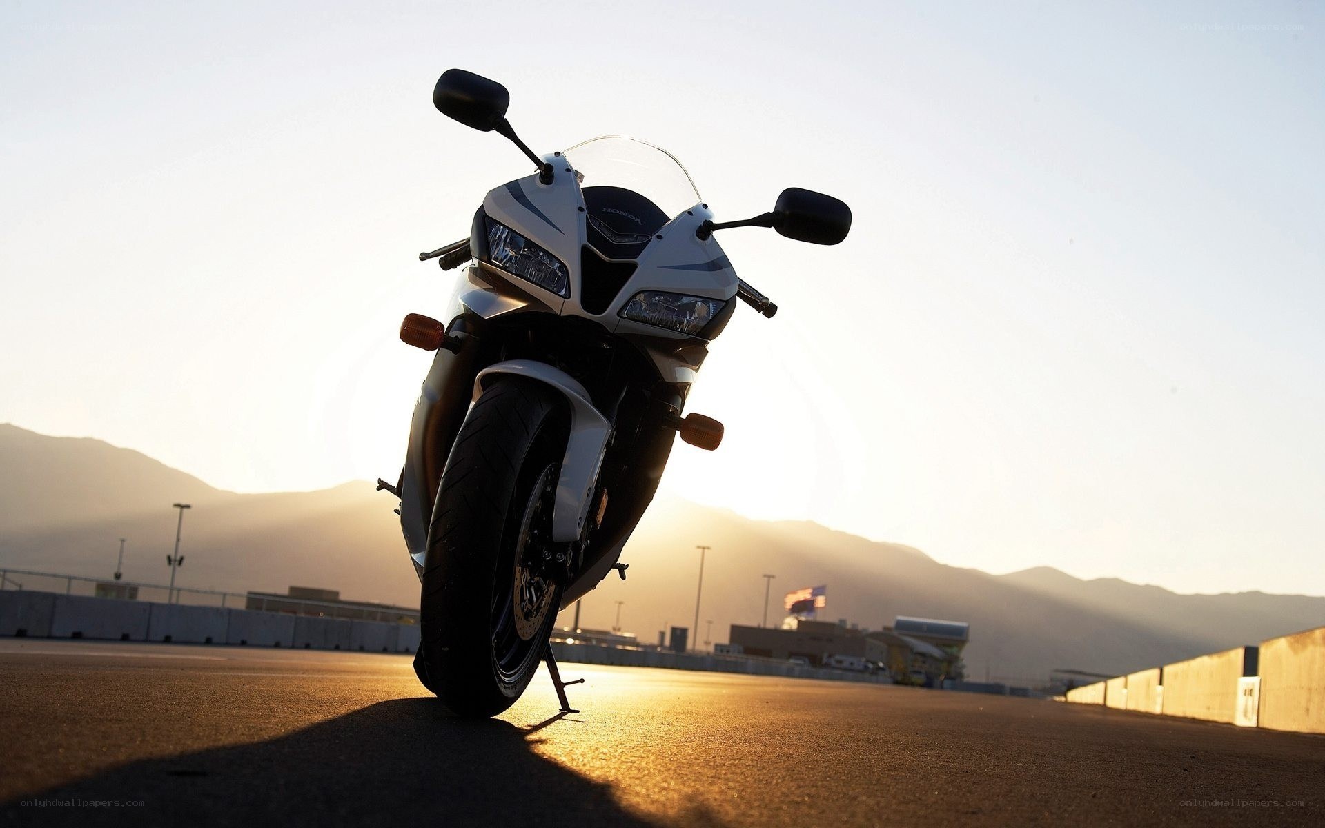 motorcycle on racetrack at sunset