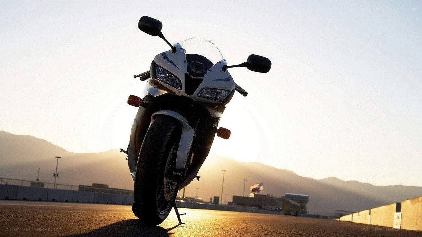 motorcycle on racetrack at sunset