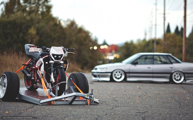 Motorcycle on trailer with car