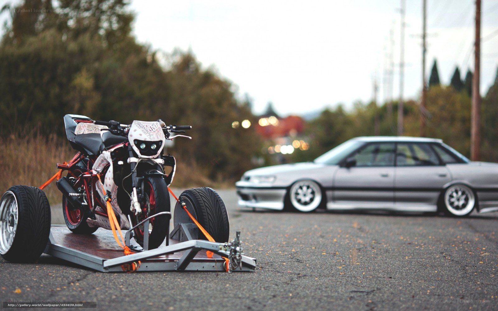 Motorcycle on trailer with car