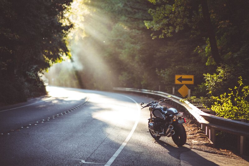 Motorcycle on Winding Road — Green, Serene, Morning