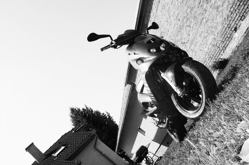 motorcycle parked by brick wall