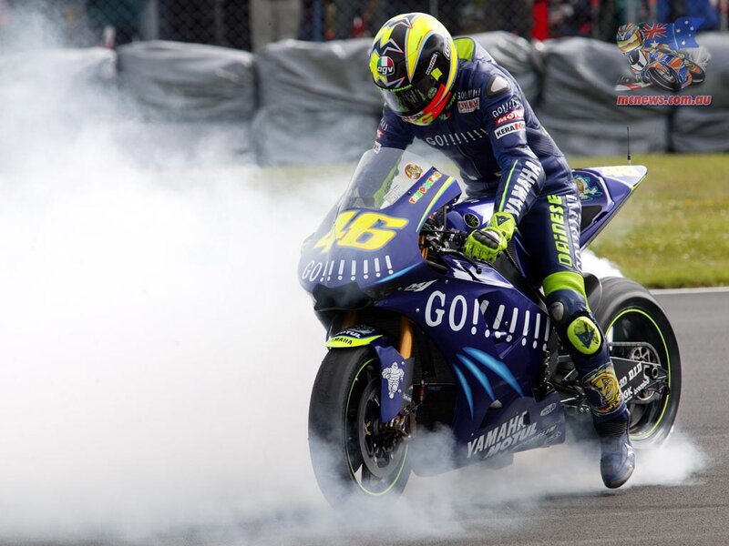 Motorcycle racer celebrating on track