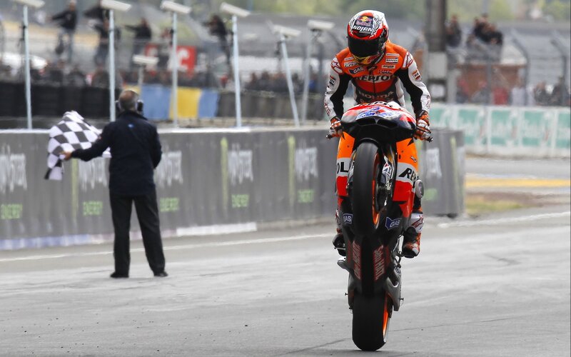 Motorcycle racer crossing finish line