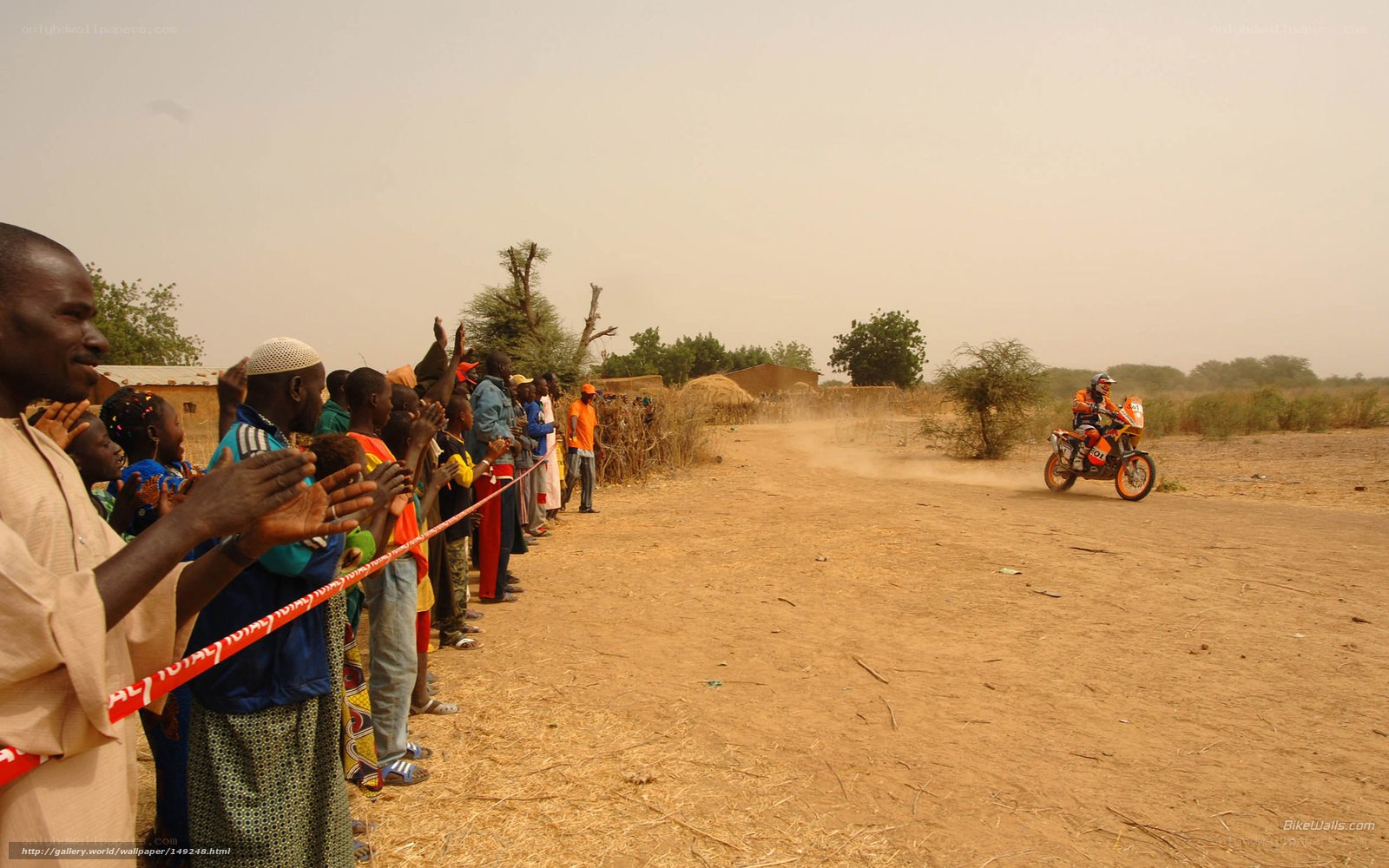 Motorcycle racer in African village