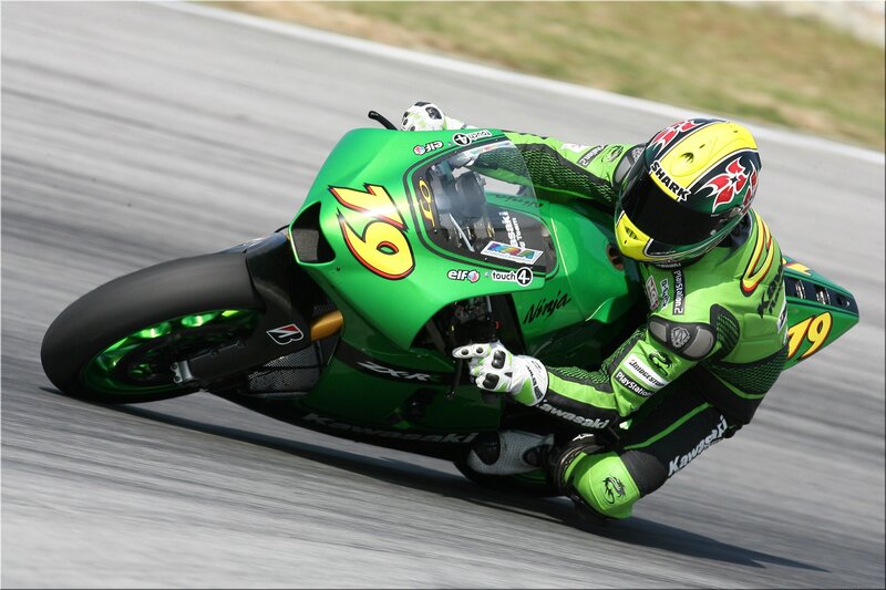Motorcycle racer on a green bike