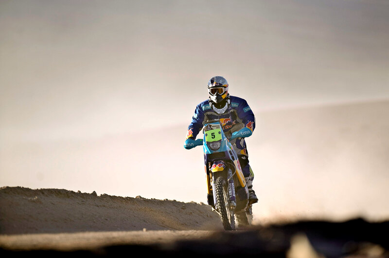 Motorcycle racer on a sand dune