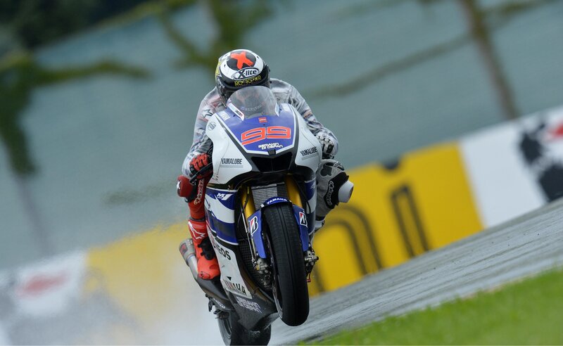 Motorcycle racer on a wet track